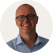 Andrew_Lavens_profile image BACKGROUND COLOUR Warm Grey_ROUND_180 px x 180 px__RGB